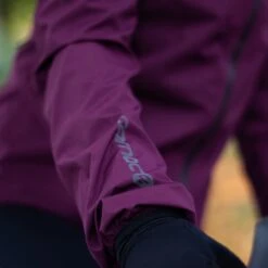 Carnac Women's Burgundy Waterproof Cycling Rain Jacket -AOI Bike Shop Close up sleeve